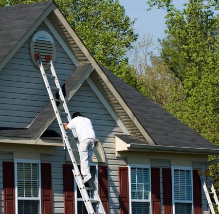 A stock photo of a man on a ladder. iStock-176856947
