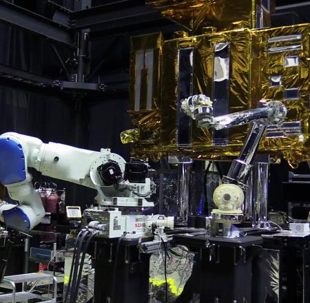 A mockup of the Landsat 7 satellite and robot arms that could be used to refuel it.