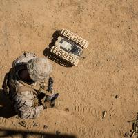 A U.S. Marine tests an unmanned ground robot. Photo: USMC