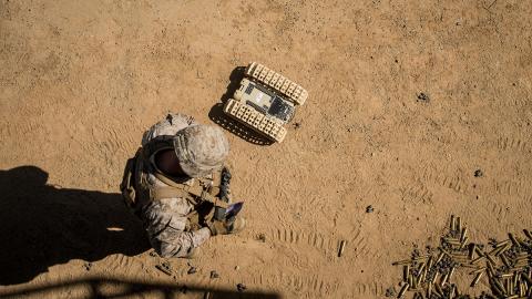 A U.S. Marine tests an unmanned ground robot. Photo: USMC A U.S. Marine tests an unmanned ground robot. Photo: USMC