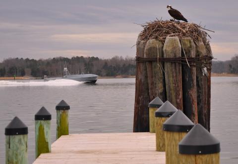 A developmental, early variant of the Common Unmanned Surface Vehicle autonomously conducts maneuvers on the Potomac River Test Range during a demonstration. (U.S. Navy)
