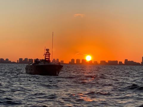 The Unmanned Influence Sweep System (UISS) heads offshore at sunrise for an Operational Assessment mission off the coast of South Florida in November 2019. Photo by U.S. Navy/RELEASED