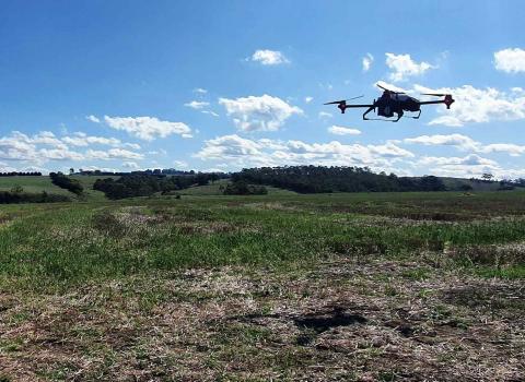XAG drone dispersing seeds from air. Photo: XAG